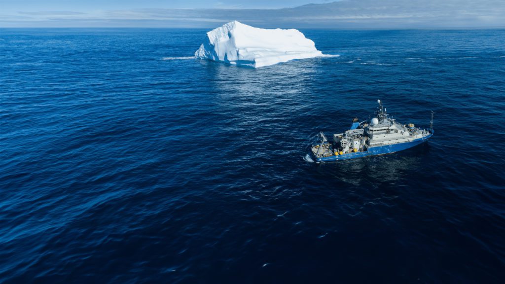 Aerial view of Armstrong sailing off the coast of Greenland near icebergs. (Photo by Croy Carlin,
© Woods Hole Oceanographic Institution)