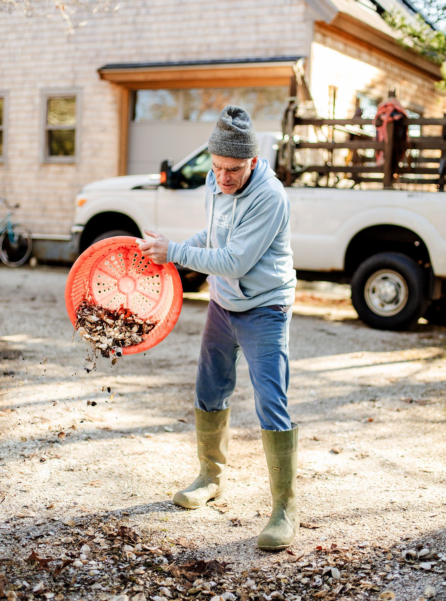 O'Connell adds clam shells to his crushed-shell driveway.