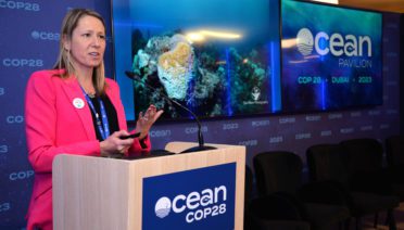 WHOI microbial ecologist Amy Apprill "speaks for the reefs" at the Ocean Pavilion during the UN climate conference COP28 in Dubai, UAE. (Photo by Elise Hugus © Woods Hole Oceanographic Institution)