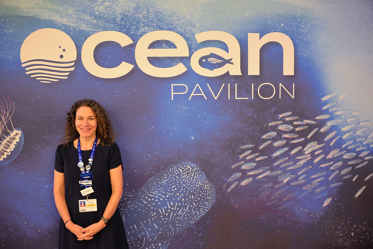 WHOI Director of Creative and Web, Katherine Spencer Joyce, poses outside of the Ocean Pavilion. (Photo by  Ken Kostel, © Woods Hole Oceanographic Institution)