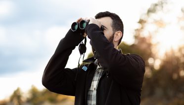 WHOI Postdoctoral Scholar Francesco Ventura scans the horizon for wildlife. (Photo by Daniel Hentz, © Woods Hole Oceanographic Institution)
