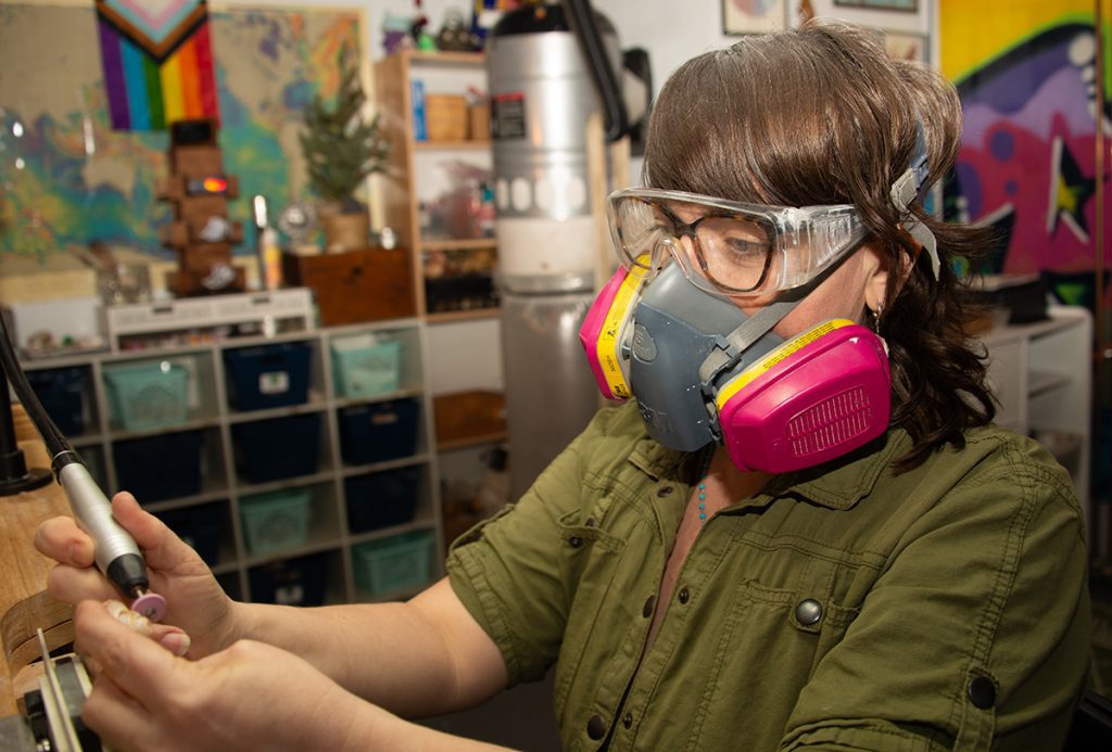 Rogers wears a respirator to protect against silica dust. (Photo by Elise Hugus/WHOI)