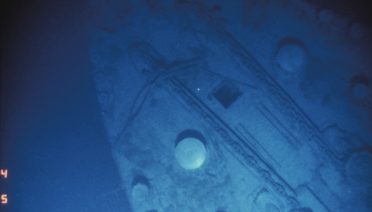 Port side of the <em>Titanic</em> bow, the two capstans and the port and starboard anchor chains are visible. (©Woods Hole Oceanographic Institution)