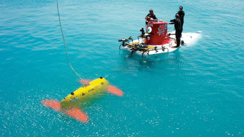 SENTRY meets the submersible ALVIN during a testing expedition off Bermuda in April 2006. SENTRY is a robotic underwater vehicle used for exploring the deep ocean; it will often be used to complement ALVIN by surveying large swaths of ocean floor to determine the best spots for close-up exploration. SENTRY joined the National Deep Submergence Facility in 2008. (Photo by Chris German, Woods Hole Oceanographic Institution)