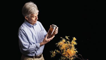 WHOI senior scientist Dennis McGillicuddy holds a jarred Sargassum sample