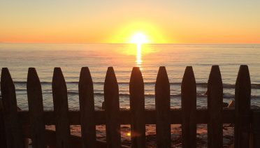 Sunset over Cape Cod Bay (photo by Kara Dodge, © Woods Hole Oceanographic Institution)