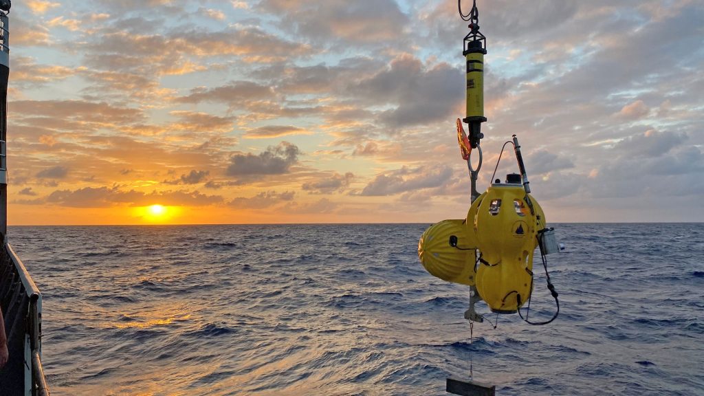 An ocean bottom seismometer being deployed by the Ocean Bottom Scismic Instrument Center during a research expedition to the Gofar transform fault in the Pacific Ocean. (Photo by Hannah Brewer, © Woods Hole Oceanographic Institution)