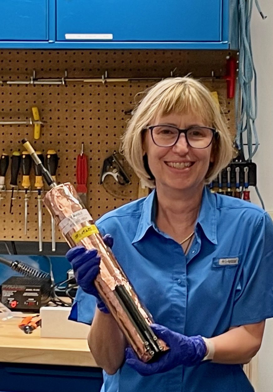 Julie Fouquet holds a copper tape-wrapped conductivity-temperature sensor