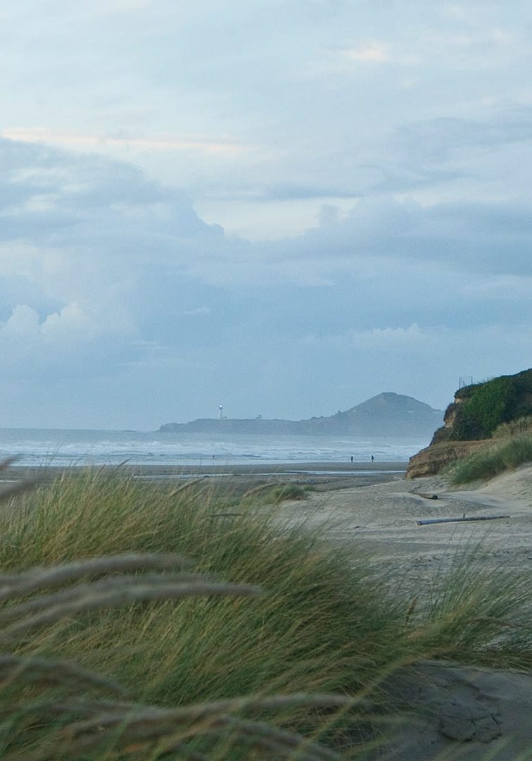 On the shore beyond the Yaquina Bay Bridge in Newport, Oregon, Ordinary Seaman Michael Sessa captured this serene vista while WHOI's research vessel <em>Atlantis</em> was in port. It takes supportcrew like Michael in addition to the cadre of scientists and engineers to carry out WHOI's mission to advance knowledge of the ocean. In his own words, Michael expresses the wonders of life at sea: "I've seen countless dolphins playing in our wake, whales swimming alongside the ship, sea lions, seals, sea otters, bioluminescence in the water at night, and sunrises and sunsets over the ocean silhouetting the California coastal mountains." (Photo by Michael Sessa, © Woods Hole Oceanographic Institution)