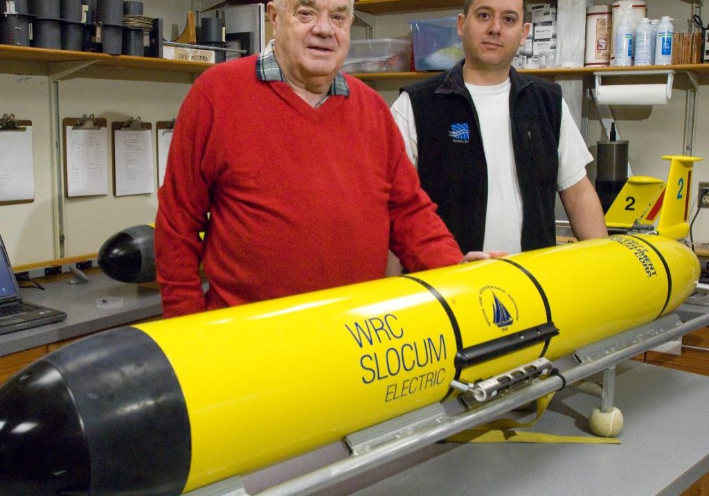 Doug Webb (left) and Dave Fratantoni (right) in front of a Slocum glider produced by Teledyne Webb Research. Photo by Tom Kleindinst © Woods Hole Oceanographic Institution
